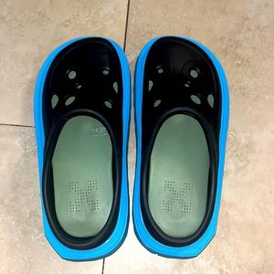 Off-White Black Crocs slippers with blue and purple rubber sole.